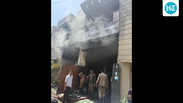 Fire brigade personnel after dousing the blaze at the building near Bharat Nagar Chowk petrol pump in Ludhiana on Wednesday. (HT Photo)