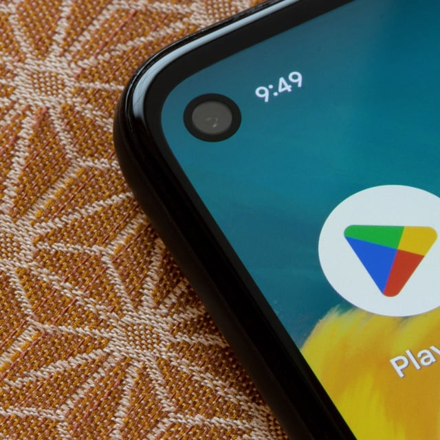 Google Play logo on an android smartphone with corner hole punch camera