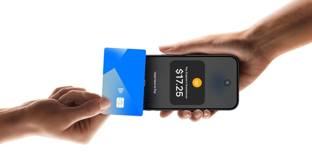 Person paying with a contactless card on an iPhone using Tap to Pay.