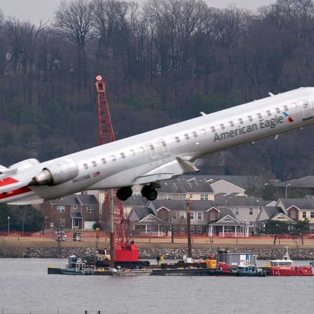 Salvage crews work on recovering wreckage near the site in the Potomac River of a mid-air collision between an American Airlines jet and a Black Hawk helicopter at Ronald Reagan Washington National Airport, Thursday, Feb. 6, 2025, in Arlington, Va. (AP Photo/Jose Luis Magana)
