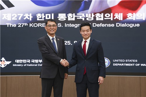 Acting Deputy Defense Minister for Policy Yoon Bong-hee (L) and John Noh, deputy U.S. assistant secretary of war for East Asia, shake hands during their defense talks in Seoul in this photo provided by South Korea's defense ministry on Sept. 24, 2025. (PHOTO NOT FOR SALE) (Yonhap)