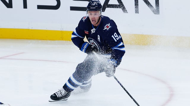Sep 23, 2025; Winnipeg, Manitoba, CAN; Winnipeg Jets forward Jonathan Toews (19) looks to make a pass in the Edmonton Oilers zone during the third period at Canada Life Centre. Mandatory Credit: Terrence Lee-Imagn Images