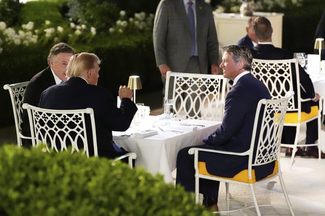 President Donald Trump sits with Sen. Dave McCormick, R-Pa., left, and Rep. Ronny Jackson, R-Texas, at a dinner in the Rose Garden of the White House, Friday, Sept. 5, 2025, in Washington. (AP Photo/Alex Brandon)