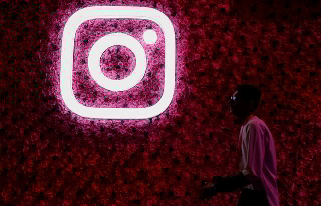 A man walks past a logo of mobile application Instagram, during a conference in Mumbai, India, September 20, 2023. REUTERS/Francis Mascarenhas/File Photo