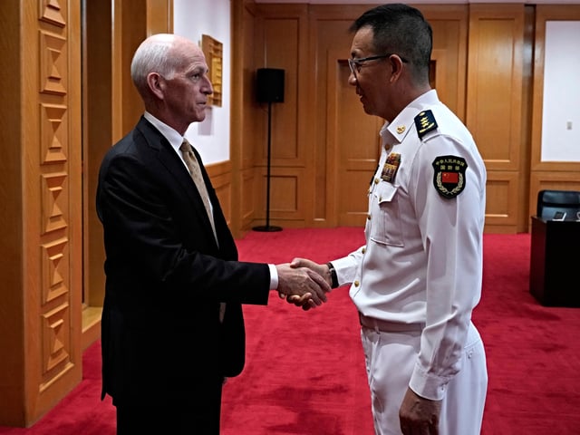 US Representative Adam Smith (L), Democratic ranking member of the House Armed Services Committee, shakes hands with China's Defence Minister Dong Jun at the Ministry of Defence in Beijing on September 22, 2025. (Photo by Mahesh Kumar A. / POOL / AFP)