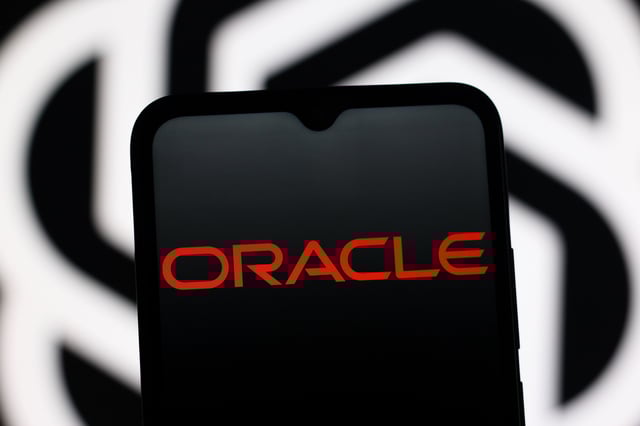 CANADA - 2025/09/13: In this photo illustration, the Oracle Corporation logo is seen displayed on a smartphone screen and the OpenAI logo in the background. (Photo Illustration by Thomas Fuller/SOPA Images/LightRocket via Getty Images)