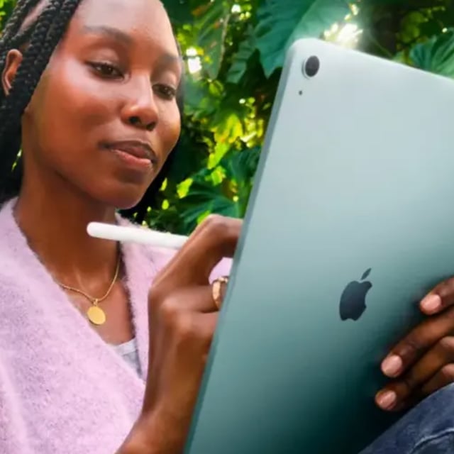 a woman writing on the m3 apple ipad air using a stylus
