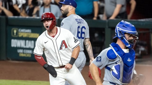 Sep 23, 2025; Phoenix, Arizona, USA; Arizona Diamondbacks base runner Tim Tawa (13) celebrates after scoring the winning run as Los Angeles Dodgers pitcher Tanner Scott (66) and catcher Ben Rortvedt react in the ninth inning at Chase Field. Mandatory Credit: Mark J. Rebilas-Imagn Images