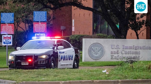 Law enforcement personnel respond at the scene of a shooting at an Immigration and Customs Enforcement (ICE) field office in Dallas