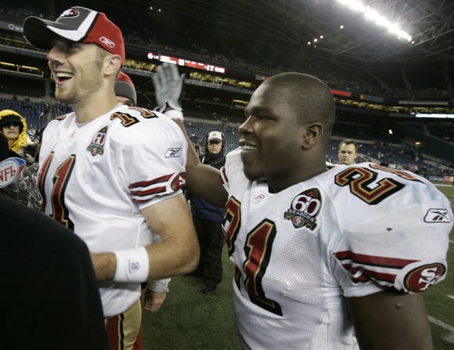 San Francisco 49ers quarterback Alex Smith, left, and running back Frank Gore, right, celebrate the 49ers' 24-14 win over the Seattle Seahawks Thursday, Dec. 14, 2006, at Qwest Field in Seattle. 