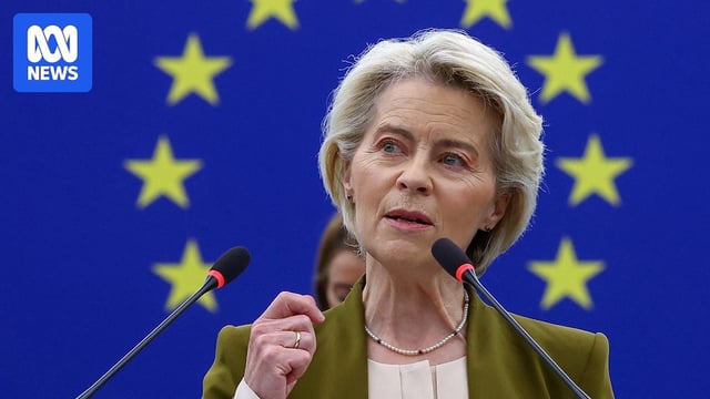 Ursula von der Leyen speaks in front of an EU flag backdrop.