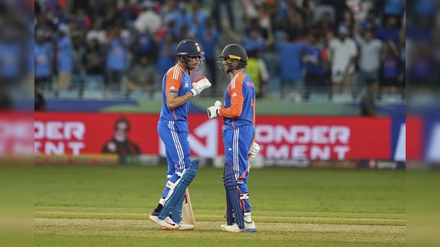 India's Shubman Gill, left, and his batting partner Abhishek Sharma talks during...