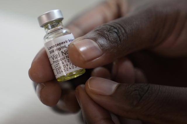 A pharmacist holds a vial of lenacapavir at a research lab in Cape Town, South Africa, July 23, 2024 (AP photo by Nardus Engelbrecht).