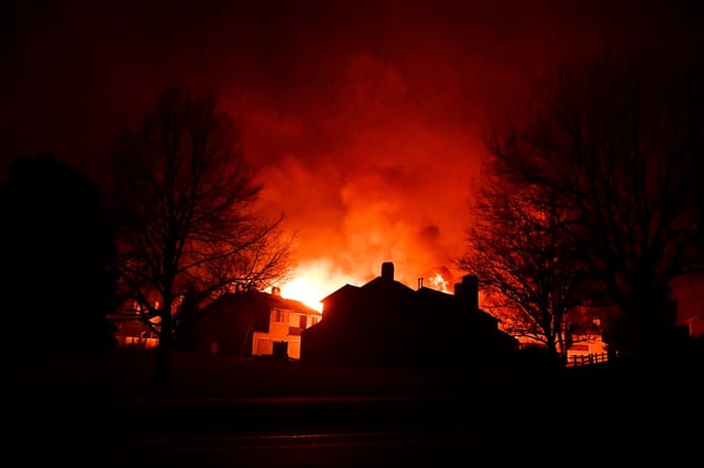Homes are engulfed in flames on December 30, 2021 in Louisville, Colorado.  Fierce winds have whipped wildfires in Boulder County, The towns of Superior and Louisville have been evacuated. Multiple homes and businesses have burned so far from the fast moving fire stocked by fierce winds, with gusts topping 100 mph, along the foothills.(Photo by Helen H. Richardson/The Denver Post