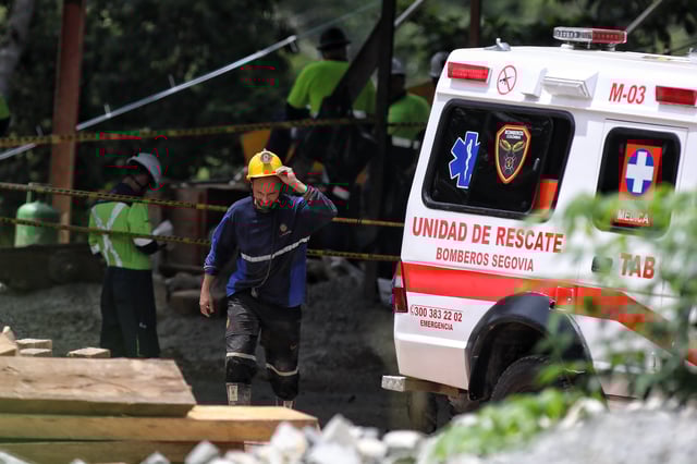 Red cross and firefighters work to rescue trapped miners after the gold mine they were working in collapsed, in Segovia, Colombia, Wednesday, Sept. 24, 2025. (AP Photo/Santiago Saldarriaga)