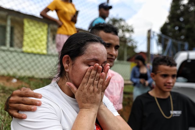Yuliana Andrea Agudelo, mother of miner Sebastian Agudelo, reacts upon hearing that her son was rescued from a gold mine that had collapsed trapping over 20 miners, in Segovia, Colombia, Wednesday, Sept. 24, 2025. (AP Photo/Santiago Saldarriaga)