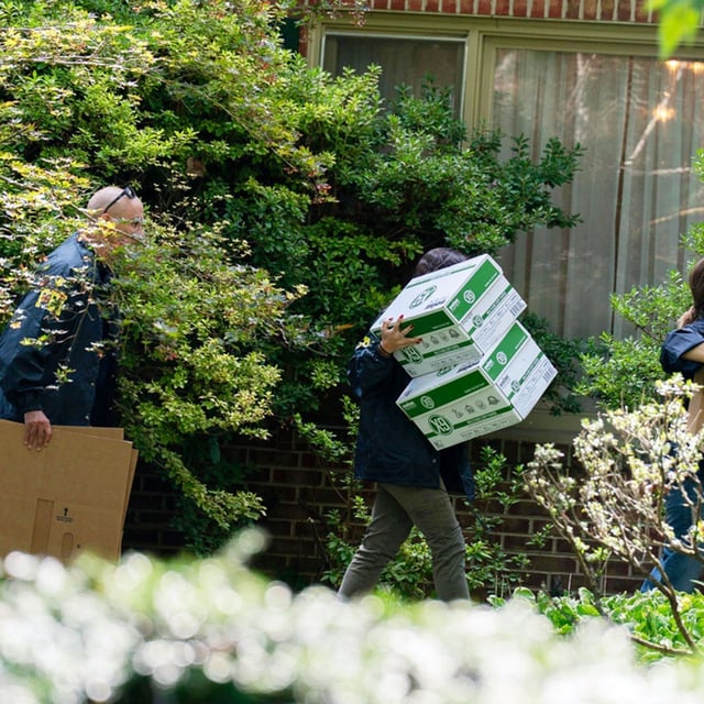 FBI agents carry empty boxes to former national security adviser John Bolton's house, Friday, August. 22, 2025, in Bethesda, Md.  (AP Photo/Jose Luis Magana)