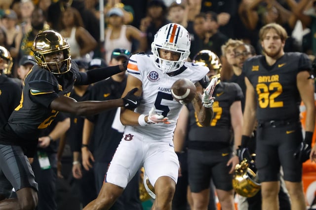 Aug 29, 2025; Waco, Texas, USA;  Auburn Tigers wide receiver Horatio Fields (5) catchesa pass against Baylor Bears safety Cameren Jenkins (23) during the second half at McLane Stadium. Mandatory Credit: Chris Jones-Imagn Images/File Photo