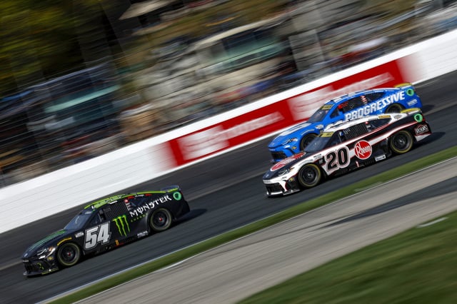 Ty Gibbs, driver of the #54 Monster Energy Toyota, Christopher Bell, driver of the #20 Rheem Toyota, and Denny Hamlin, driver of the #11 Progressive Toyota, race during the NASCAR Cup Series Mobil 1 301 at New Hampshire Motor Speedway on September 21, 2025 in Loudon, New Hampshire.