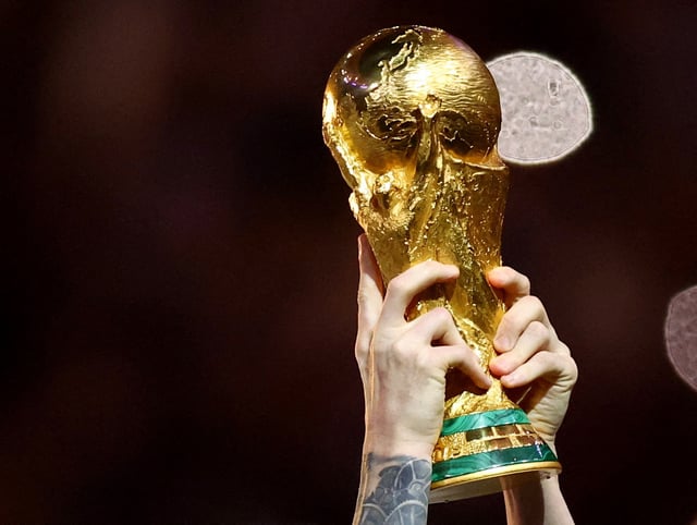 Soccer Football - FIFA World Cup Qatar 2022 - Final - Argentina v France - Lusail Stadium, Lusail, Qatar - December 18, 2022  General view of Argentina's Lionel Messi lifting the trophy as he celebrates winning the World Cup REUTERS/Hannah Mckay/File Photo