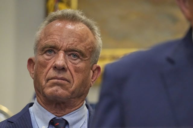 Health and Human Services Secretary Robert F. Kennedy Jr. listens as President Donald Trump speaks in the Roosevelt Room of the White House, Monday, Sept. 22, 2025, in Washington. (AP Photo/Mark Schiefelbein)