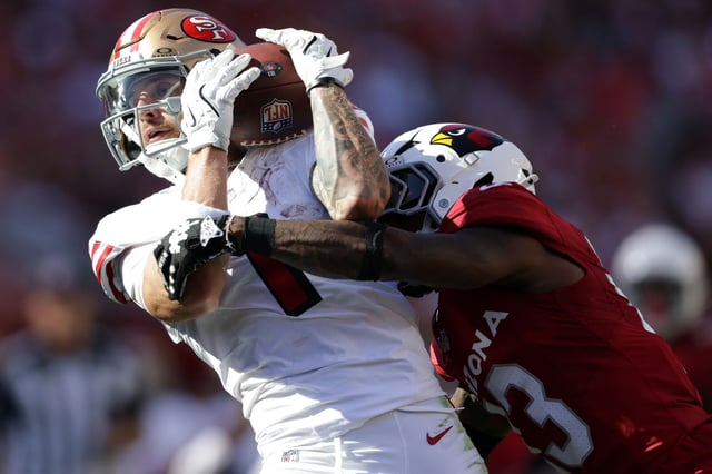 49ers wide receiver Ricky Pearsall catches a 34-yard pass that bounced off his helmet against the Arizona Cardinals’ Kei-Trel Clark in the fourth quarter of San Francisco’s 16-15 win Sunday at Levi’s Stadium.