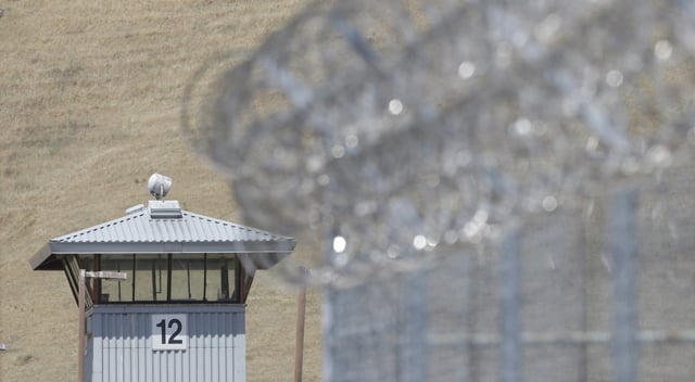 A guard tower and razor wire are seen at California State Prison, Solano in Vacaville, Calif. The overcrowded California prison was running on emergency generator power for a third day Tuesday, July 16, 2024, following a major electrical outage in the area over the weekend amid a heat wave. (AP Photo/Rich Pedroncelli, File)