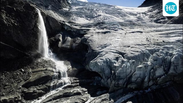 A drone view shows water from melting ice running down the side of the Turtmann glacier on a warm summer day, amid climate change, in Turtmann, Switzerland on September 3. (REUTERS)