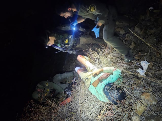 U.S. Border Patrol agents work to rescue a cyclist who suffered serious injuries after he fell 50 feet from a cliff near Savage Dam outside Chula Vista on Saturday. (U.S. Border Patrol)