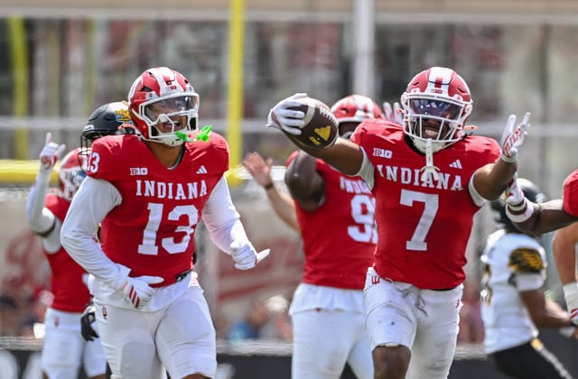 Sep 6, 2025; Bloomington, Indiana, USA; Indiana Hoosiers defensive lineman Kellan Wyatt (13) and defensive back Louis Moore (7) celebrate after forcing a turnover during the second half against the Kennesaw State Owls at Memorial Stadium. Mandatory Credit: Robert Goddin-Imagn Images/File Photo