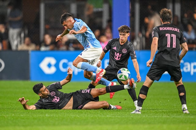 Sep 24, 2025; New York, NY, New York, NY, USA; Inter Miami midfielder Sergio Busquets (5) slides to steal the ball from New York City FC forward Nicolas Fernandez (7) during the first half at Citi Field. Mandatory Credit: Mark Smith-Imagn Images