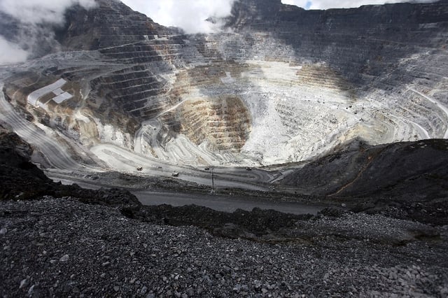 Trucks operate in the open-pit mine of PT Freeport's Grasberg copper and gold mine complex near Timika, in the eastern region of Papua, Indonesia on September 19, 2015 in this photo taken by Antara Foto. REUTERS/Muhammad Adimaja/Antara Foto/File Photo