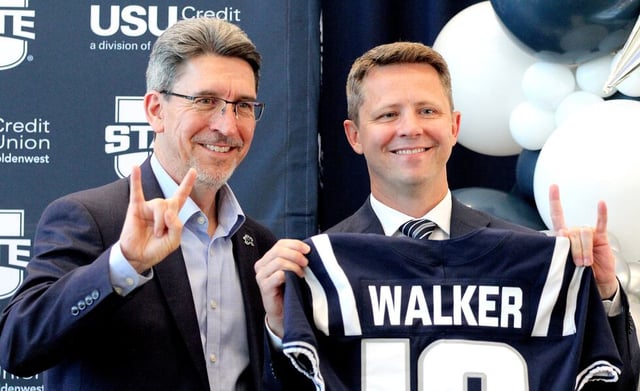 Interim Utah State University President Alan Smith, left, and new USU athletic director Cameron Walker pose for photographs at the conclusuion of Wednesday's press conference at the West Stadium Center at Maverik Stadium in Logan. (Jeff Hunter)