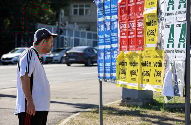 A man stands in front of a board with Moldovan political parties' campaign posters ahead of the upcoming parliamentary elections in Chisinau, Moldova, September 21, 2025. REUTERS/Vladislav Culiomza/File Photo