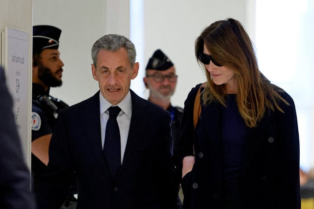 Former French President Nicolas Sarkozy arrives with his wife Carla Bruni-Sarkozy for the verdict in his trial with other defendants on charges of corruption and illegal financing of an election campaign related to alleged Libyan funding of his successful 2007 presidential bid, at the courthouse in Paris, France, September 25, 2025. REUTERS/Stephanie Lecocq