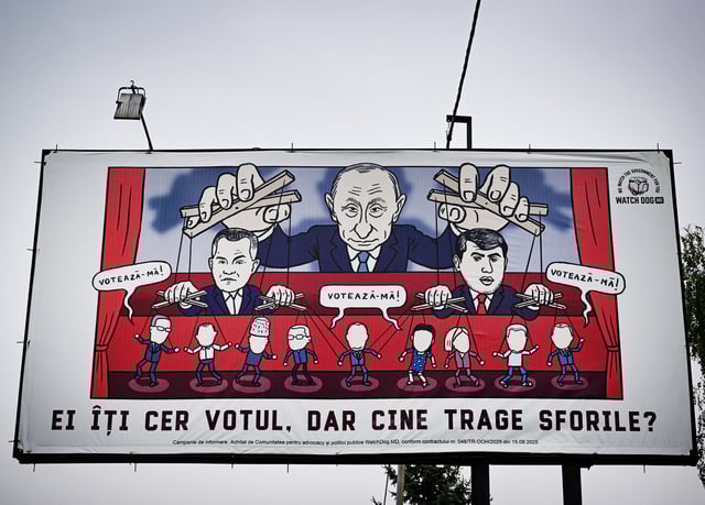 This photograph shows a caricature on a billboard bearing Russian President Vladimir Puting pulling the ropes of fugitives Ilan Shor (R) and Vladimir Plahotniuc (L) and reading "They ask for your vote" in Ungheni city on September 24, 2025. The ex-Soviet republic, wedged between war-torn Ukraine and EU member Romania, has repeatedly warned of in Russian interference. Moldovan authorities claims the Kremlin is pouring hundreds of millions of euros to buy hundreds of thousands of votes", urging citizens to prevent the return to power of "those who now buy votes". Moldovans will vote in tense parliamentary elections on September 28. (Photo by Daniel MIHAILESCU / AFP) (Photo by DANIEL MIHAILESCU/AFP via Getty Images)