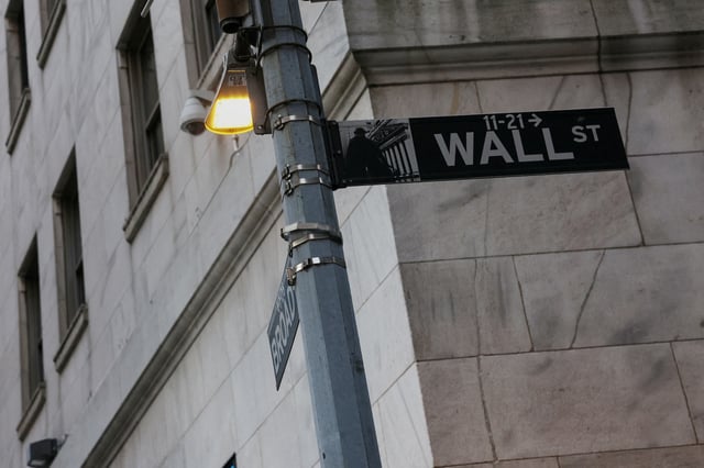 The Wall street sign hangs outside the New York Stock Exchange (NYSE) building on Tuesday following Monday’s broad sell off in New York City, U.S., March 11, 2025. REUTERS/Shannon Stapleton/File Photo