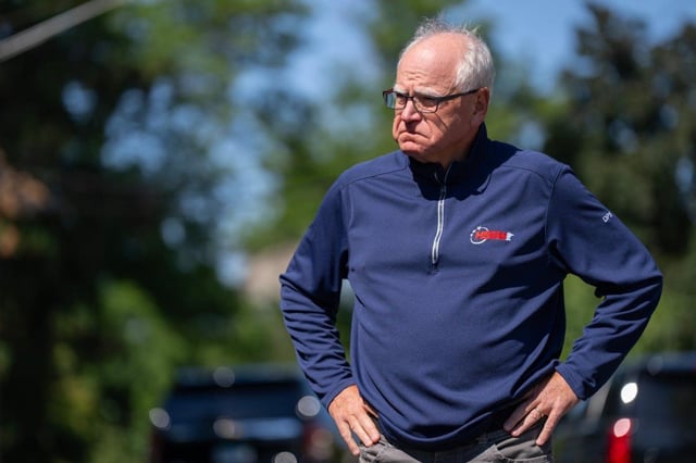 Tim Walz waits to address the media outside Annunciation Catholic Church and School in Minneapolis after a mass shooting there on Aug. 27. (Alex Kormann/Minnesota Star Tribune/TNS)