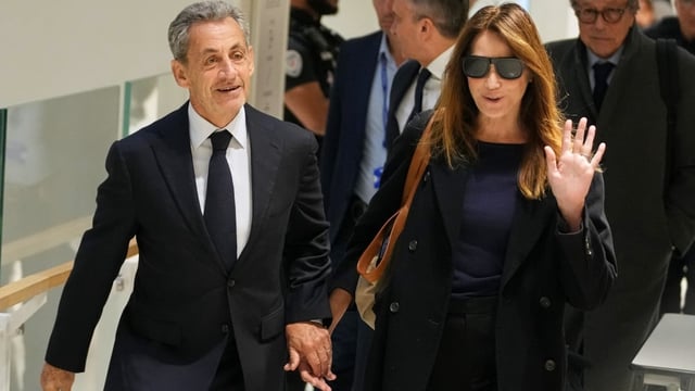 Former French president Nicolas Sarkozy, left, and his wife Carla Bruni-Sarkozy,  are shown arriving at the courthouse in Paris on Thursday.