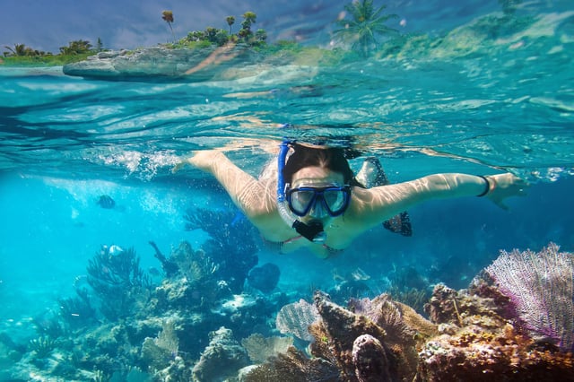 A stock image of a woman snorkeling in Mexico.