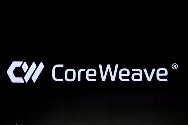 A screen displays the company logo for CoreWeave Inc., Nvidia-backed cloud services provider, during the company's IPO at the Nasdaq Market, in New York City, U.S., March 28, 2025. REUTERS/Brendan McDermid/File Photo