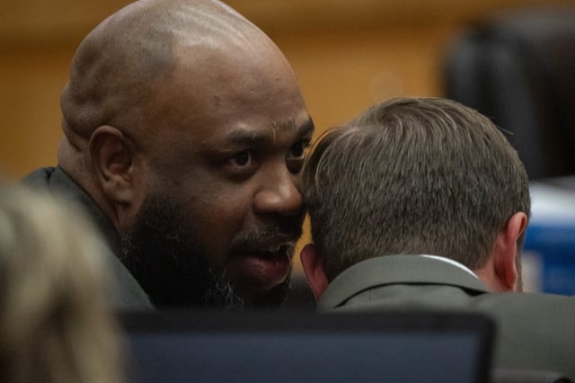 Cleophus Cooksey Jr. (left) talks with attorney Adrian Little during his trial in Maricopa County Superior Court, on May 5 2025. Cooksey is accused of killing eight people over a three-week span in late 2017.