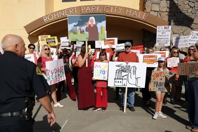 Residents stand in front of Rohnert Park’s City Hall to protest the proximity of plastics recycling plant Resynergi.