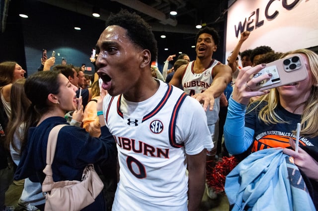 Auburn Tigers guard Tahaad Pettiford (0) celebrates with students as Auburn Tigers take on Tennessee Volunteers at Neville Arena in Auburn, Ala., on Saturday, Jan. 25, 2025. Auburn Tigers defeated Tennessee Volunteers 53-51.