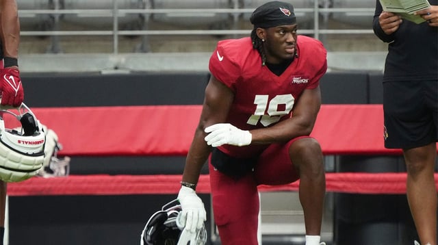 Arizona Cardinals receiver Marvin Harrison Jr. (18) watches from the sidelines during the team's practice at State Farm Stadium on July 29, 2025.