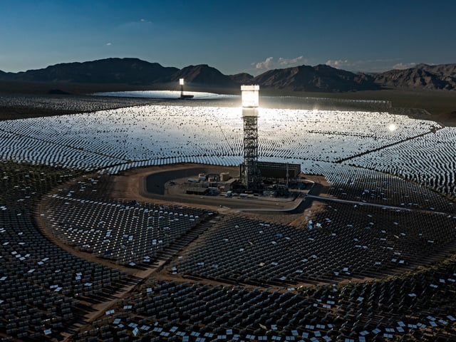 NIPTON, CA - AUGUST 26: In an aerial view, a boiler tower is surrounded by mirrors at the Ivanpah Solar Electric Generating System in the Mojave Desert on August 26, 2022 near Nipton, California. As drought, wildfires and monsoonal desert flash floods worsen in California, the development of solar energy farms has become prioritized as a means to lessen some of the worst impacts of human-caused climate change. Ironically, this "green energy" is harming the environment as it sprawls across pristine desert land, which stores carbon in the ground. California deserts account for nearly 10 percent of the states carbon sequestration. The Ivanpah Solar Electric Generating System is one of the biggest but has been challenged by reports that thousands of birds have been incinerated mid-flight by intense heat in the concentrated sun rays that are reflected to giant boiler towers. (Photo by David McNew/Getty Images)