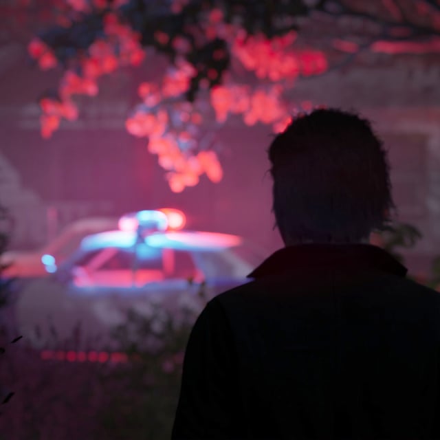 Michael Myers ominously looks at a town scene.