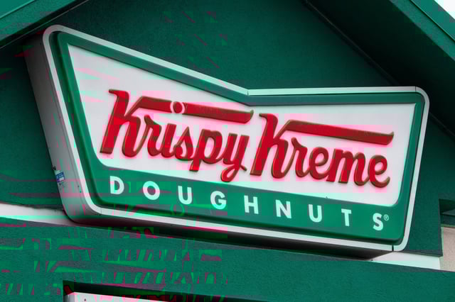The Krispy Kreme corporate logo is displayed on a sign at their store on January 31, 2025 in San Diego, California