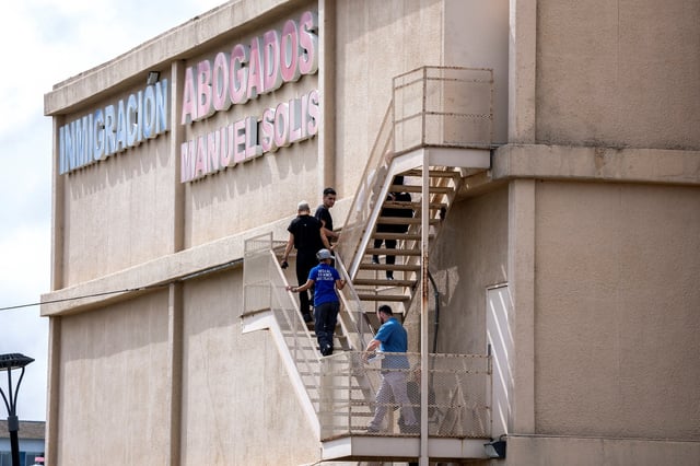 Personnel from the medical examiner's office respond at the scene of a shooting at an Immigration and Customs Enforcement (ICE) field office in Dallas, Texas, U.S., September 24, 2025. REUTERS/Jeffrey McWhorter