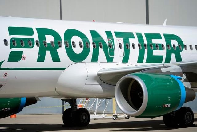 DENVER, CO - SEPTEMBER 9: Frontier employees and executives physically pull a 46-ton Airbus A320 out of the Frontier Airlines hanger at Denver International Airport in Denver. The plane reveals the new paint scheme of the Frontier logo reverting to the stylized "F" to look like that from the logo first introduced in 1978. The iconic animals on the plane's tale will stay and will be featured more prominently extending from the tale to the aft fuselage of the aircraft. (Kathryn Scott Osler/The Denver Post)